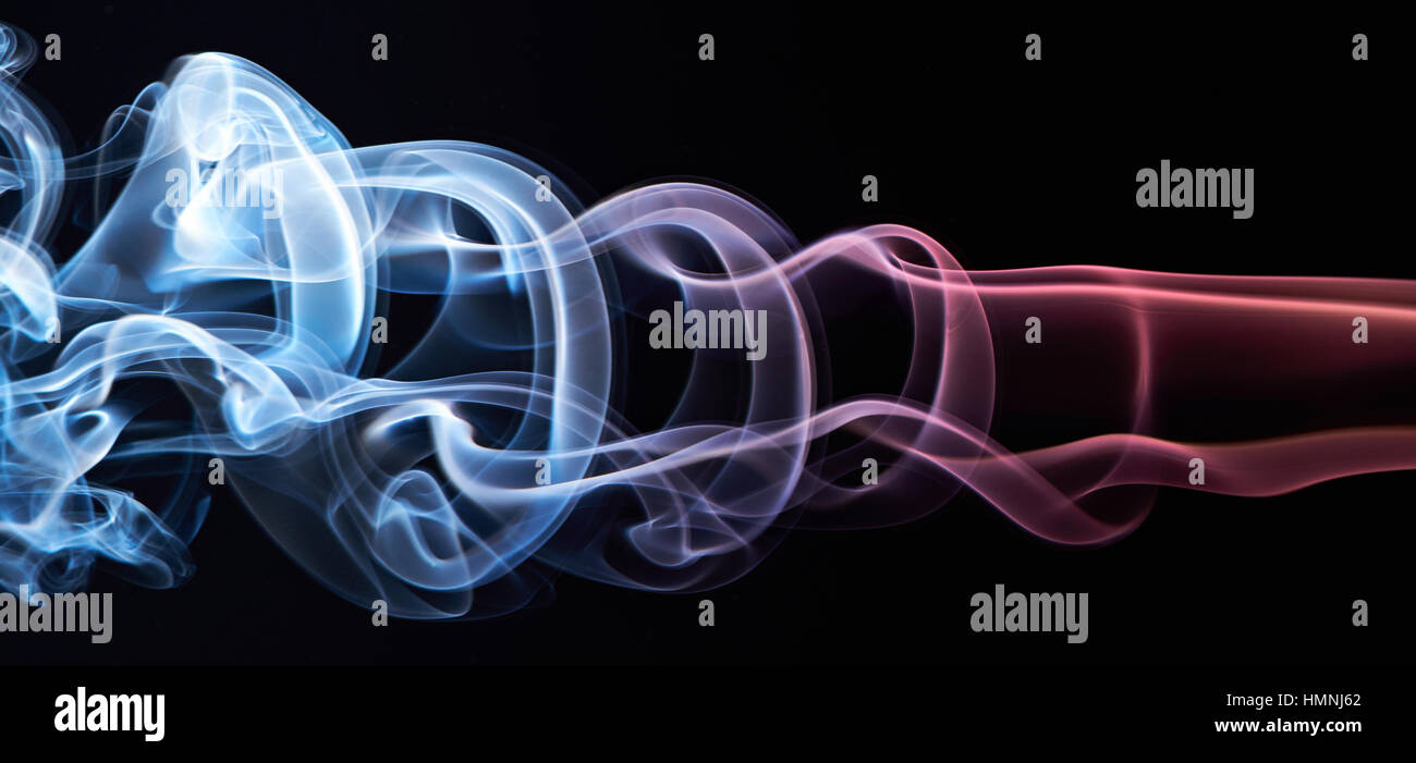 Round circles of colored smoke isolated on black Stock Photo