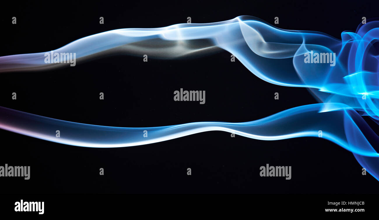 two blue smoke lines isolated on black background Stock Photo