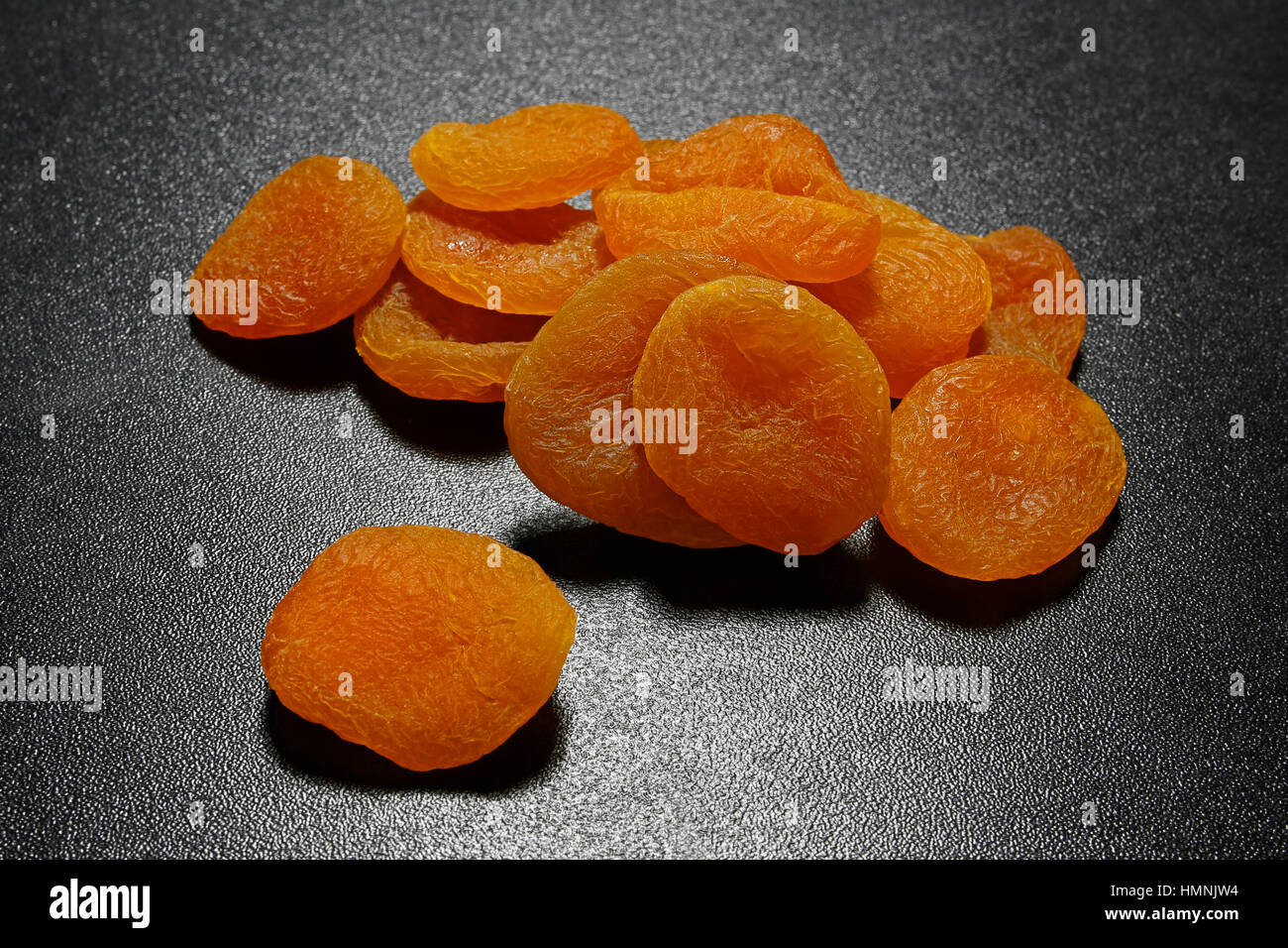 dried apricots on black shiny background Stock Photo Alamy