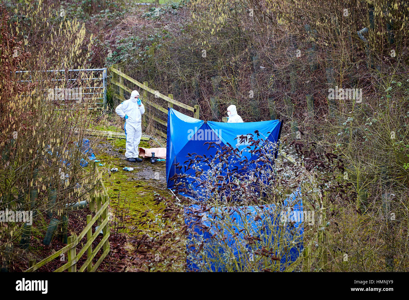 Forensic officers investigate the scene where human remains where found. A routine Thames Valley Police patrol made the grisly find on a slip road between the A404 and M40 motorway at the Handy Cross Roundabout. Stock Photo
