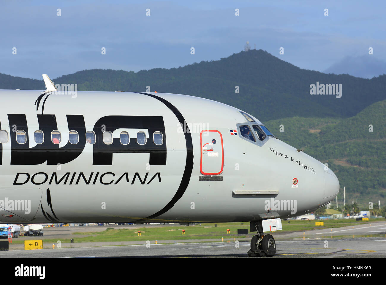 A jet airliner of the Dominican Republic in the Caribbean prepares for take-off from Sint Maarten (SXM) Stock Photo