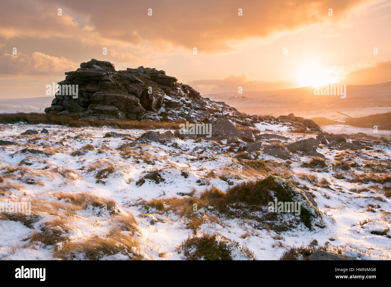 Golden sunset on snow covered Higher Tor Dartmoor National Park Devon UK Stock Photo