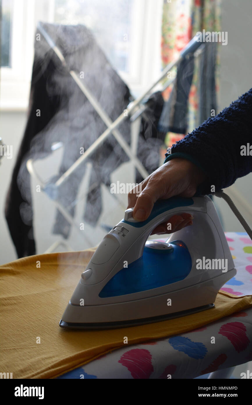 Laundry day. Woman doing the ironing. Stock Photo