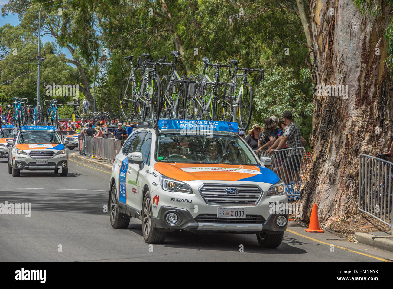 The Tour Down Under races around the street circuit of central Adelaide and is serviced by the professional team cars following the racers closely Stock Photo