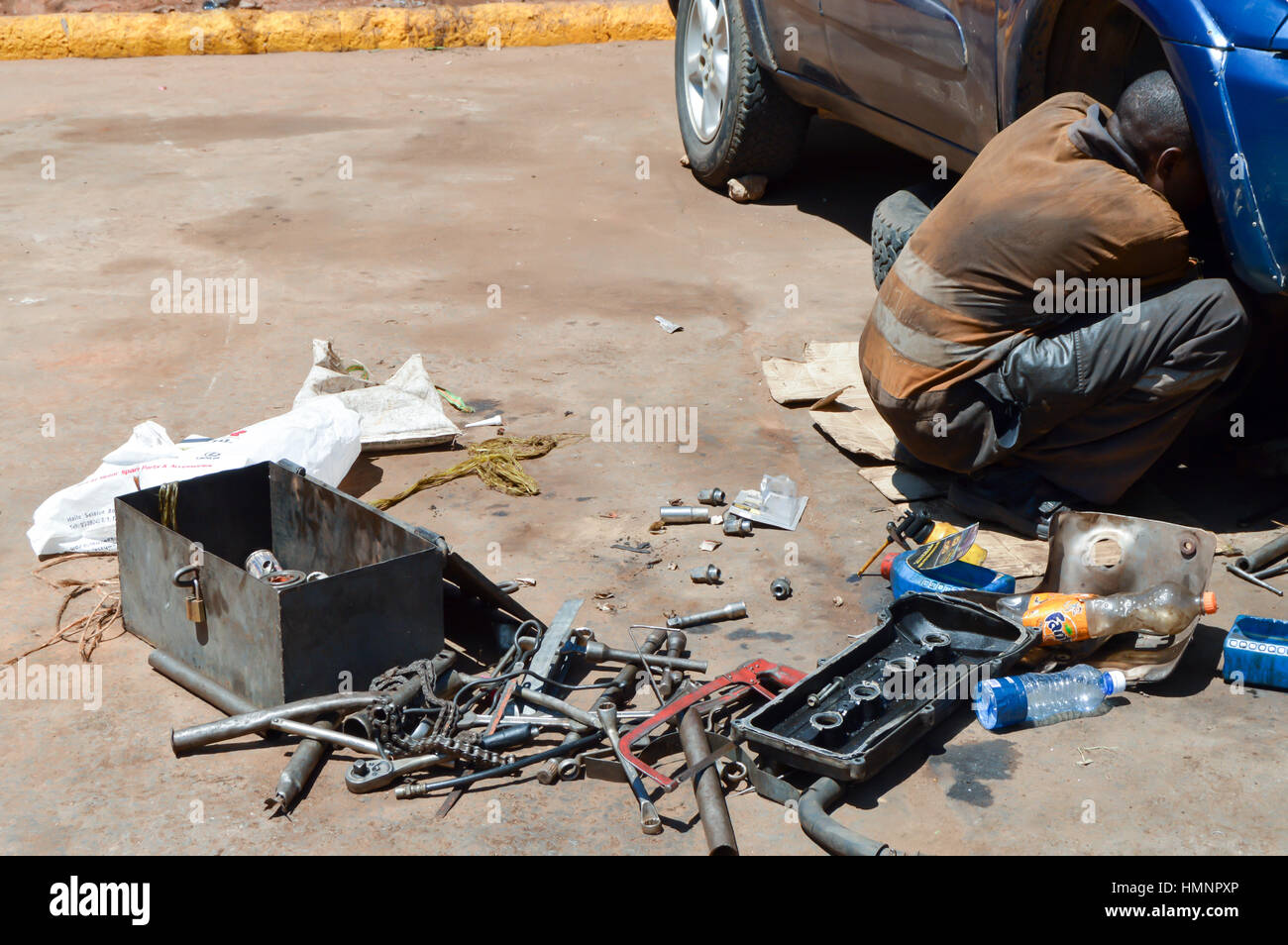 Mechanic car in full working on the floor on a parking lot in Kenya Stock Photo Alamy