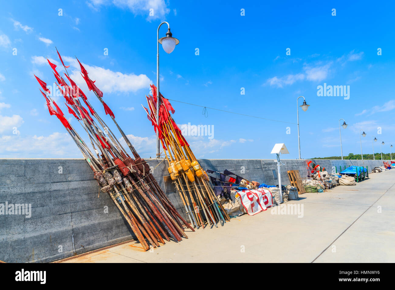 Poles to mark fishing area in in Kuznica port on Hel peninsula, Baltic Sea, Poland Stock Photo