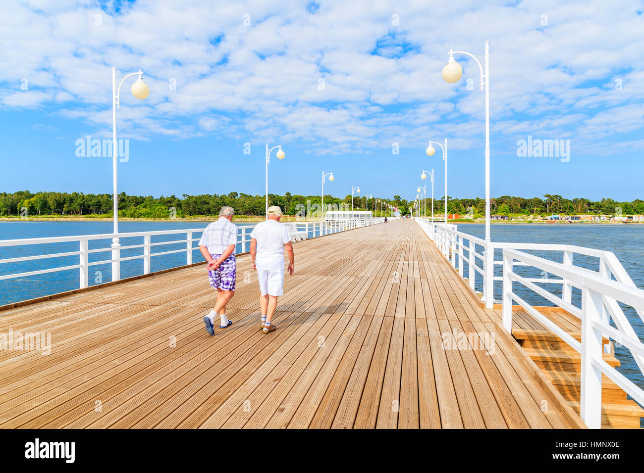 Old couple walking on beach hi-res stock photography and images - Alamy