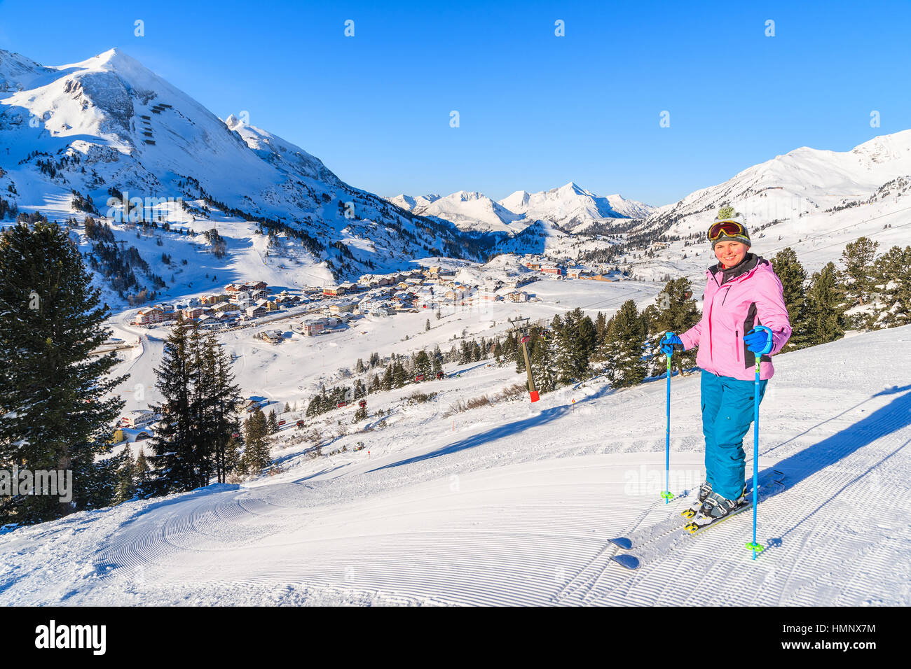 Young woman skier standing on ski run in Obertauern resort, Austria Stock Photo