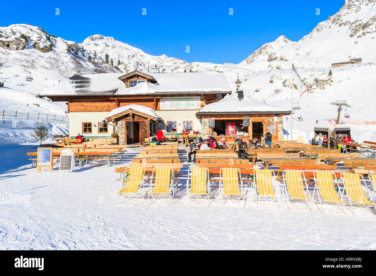 OBERTAUERN SKI RESORT, AUSTRIA - JAN 22, 2017: sunchairs of mountain hut in Obertauern ski area in Salzburg land, Austrian Alps. Stock Photo