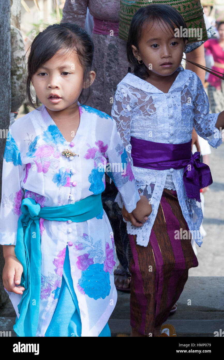 Two young girls entering the temple during the Galungan festival in Bali, Indonesia Stock Photo