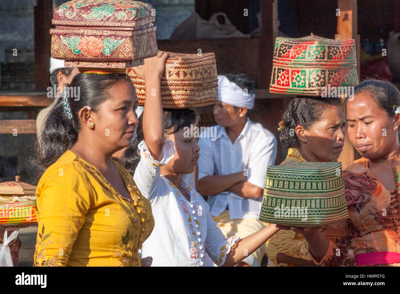 Women with baskets of offerings at the temple during the Galungan festival in Bali, Indonesia Stock Photo