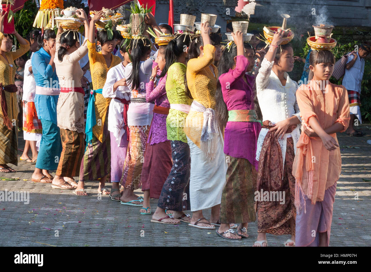 Young girls forming a procession of offerings at the Galungan festival in Bali, Indonesia Stock Photo