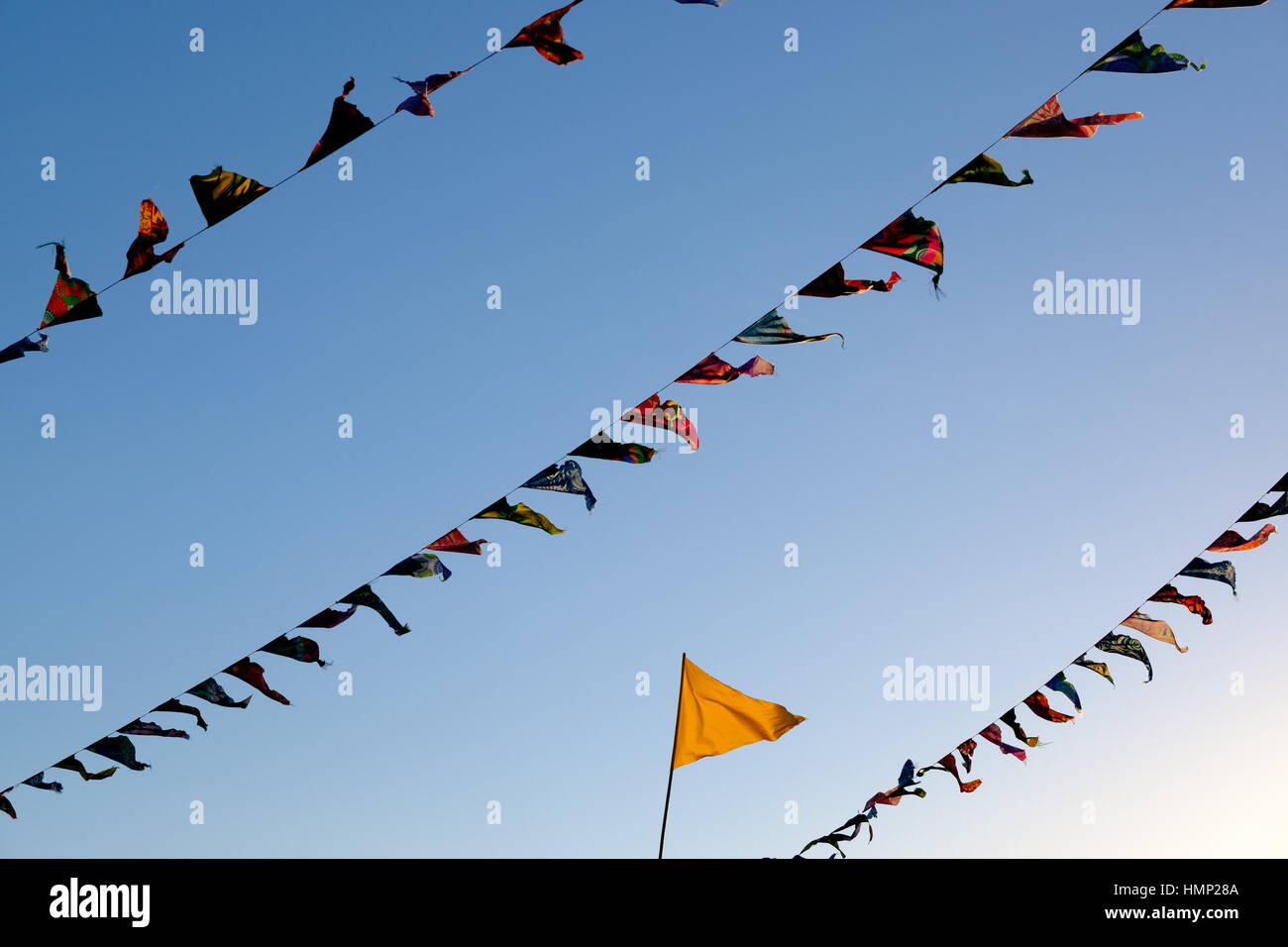 Flags and bunting against a blue sky in late afternoon Stock Photo - Alamy