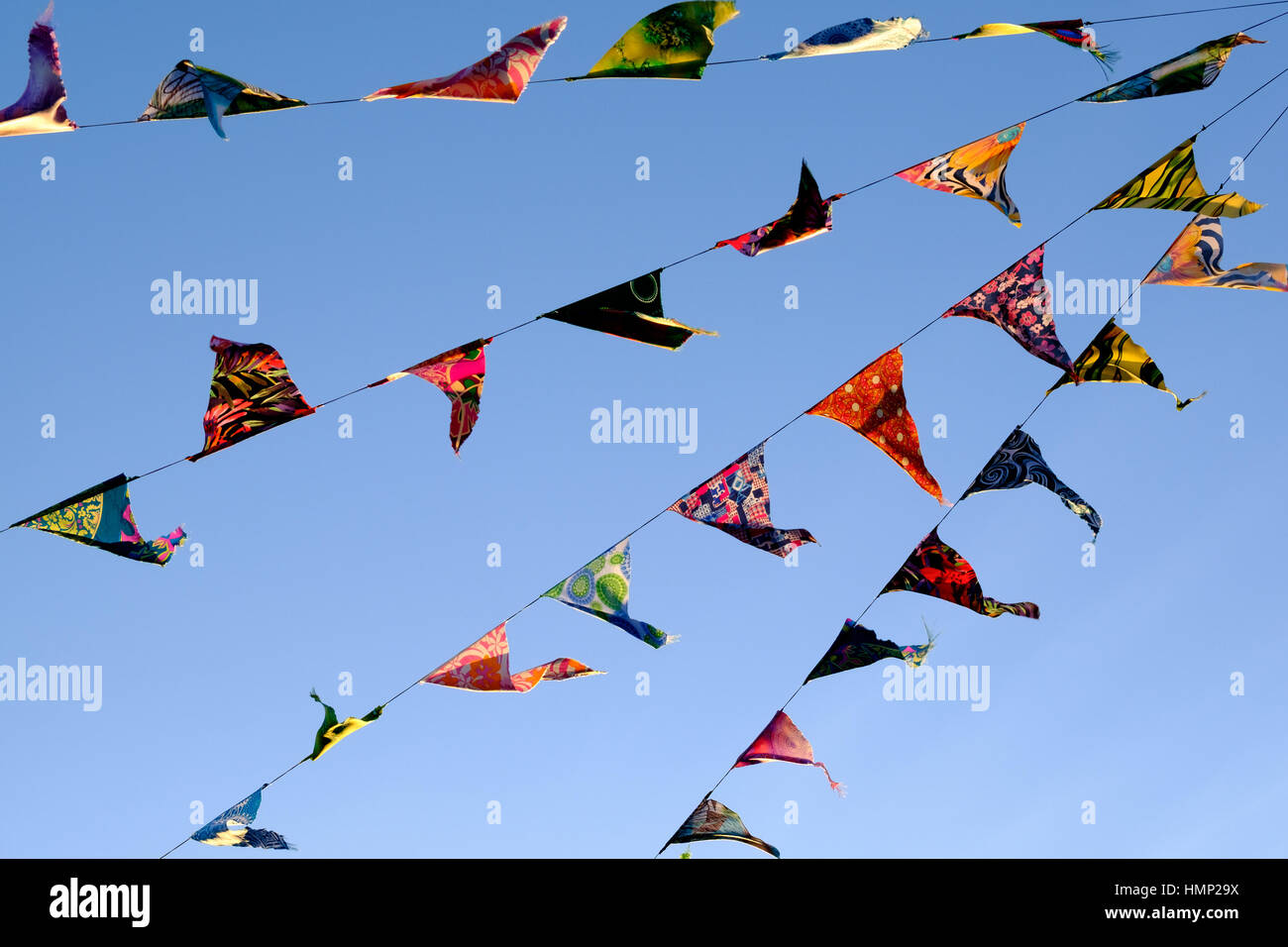 Flags and bunting against a blue sky in late afternoon Stock Photo
