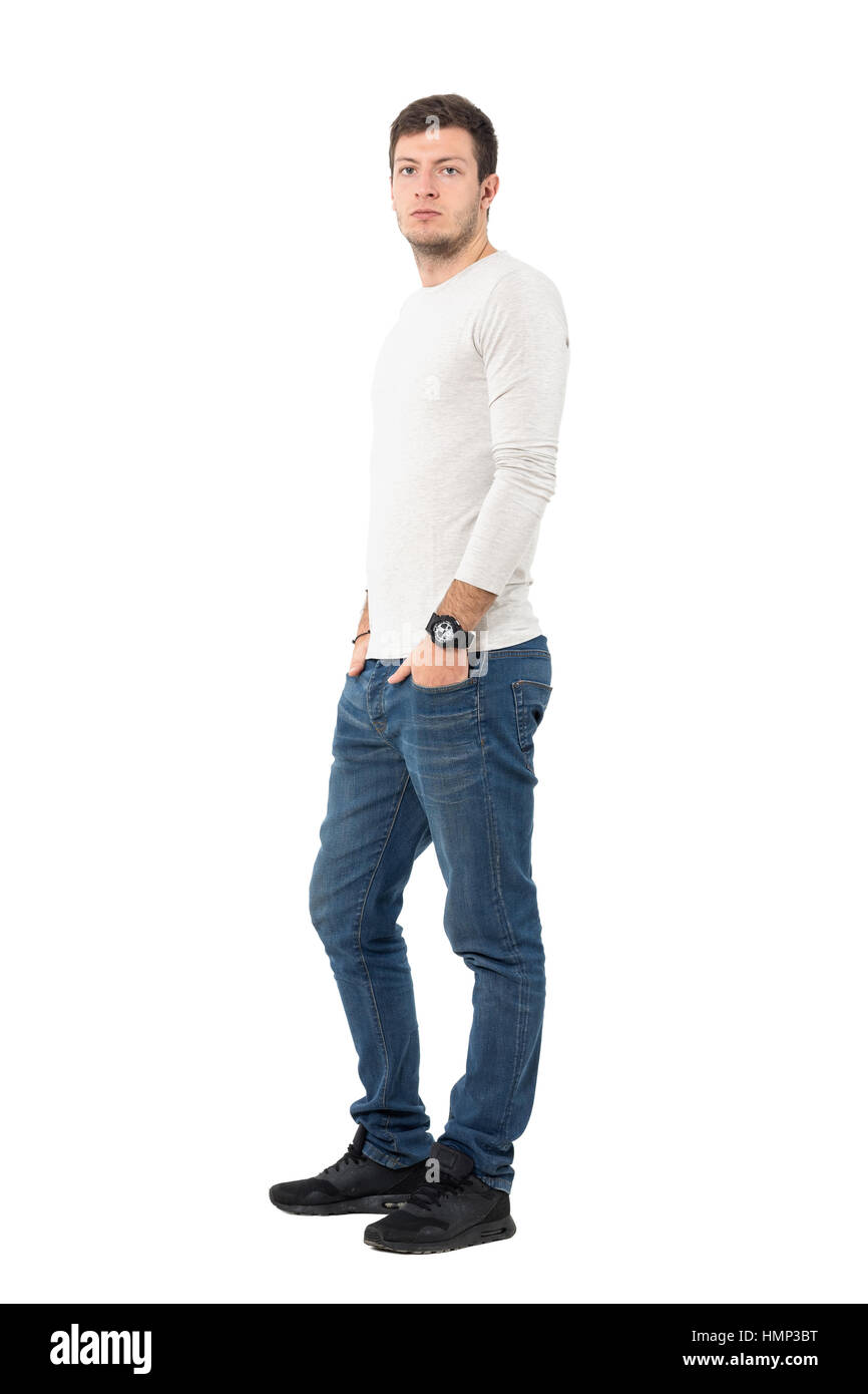 Side view of young serious casual man wearing jeans and sneakers looking at  camera. Full body length portrait isolated over white studio background  Stock Photo - Alamy