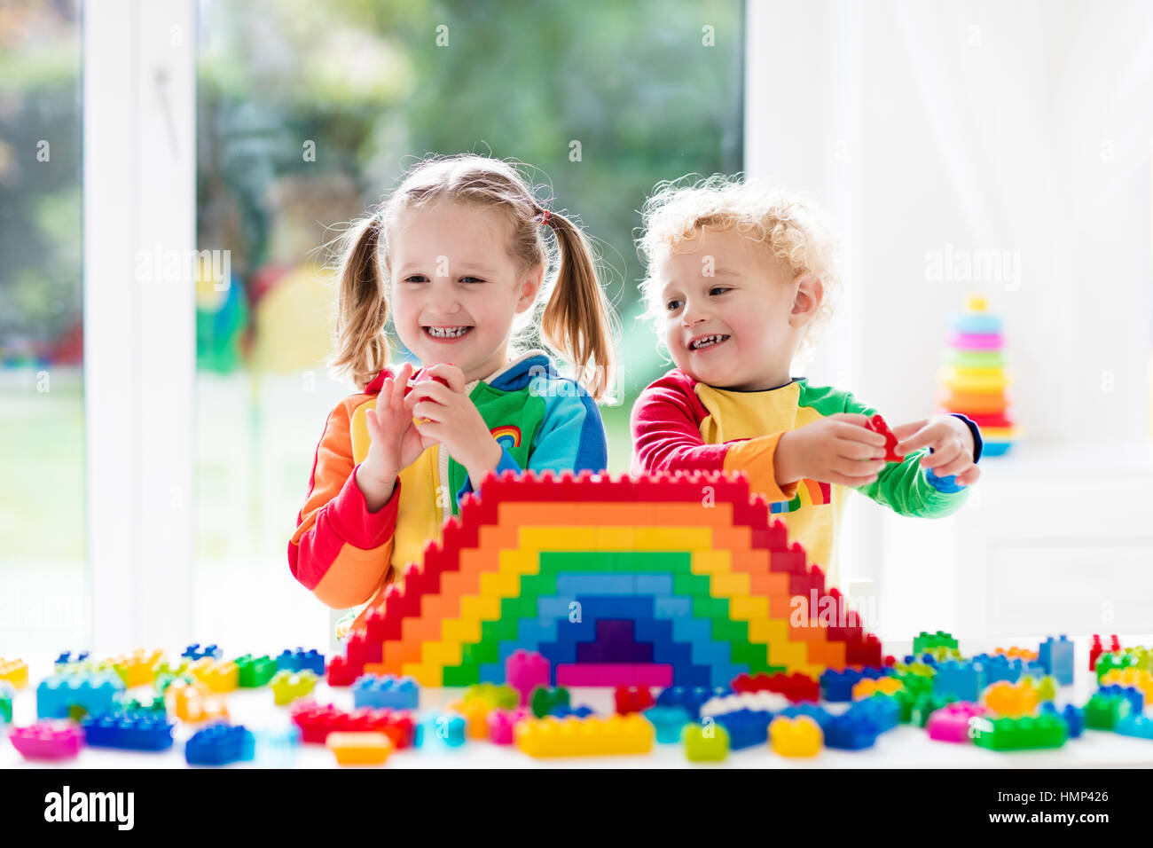 Kids playing with colorful blocks Stock Photo - Alamy