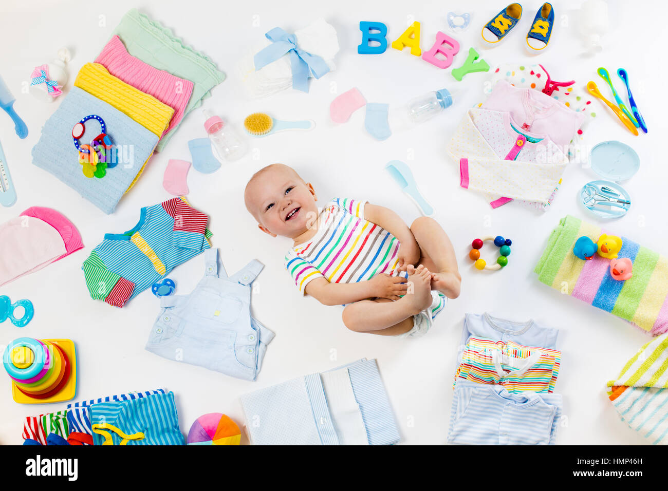 Baby on white background with clothing, toiletries, toys and health ...