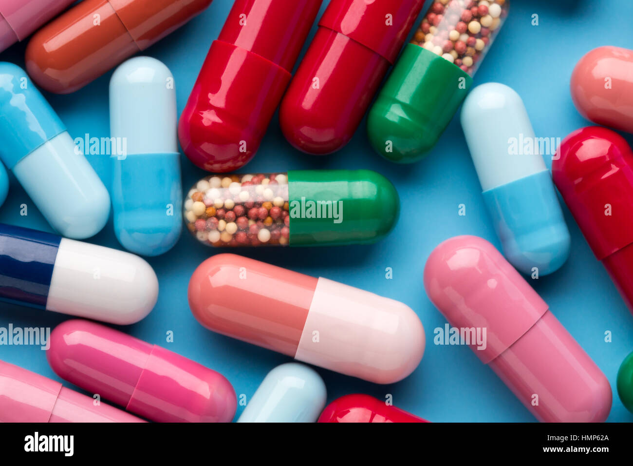 Colorful different medicine capsules on blue background Stock Photo Alamy
