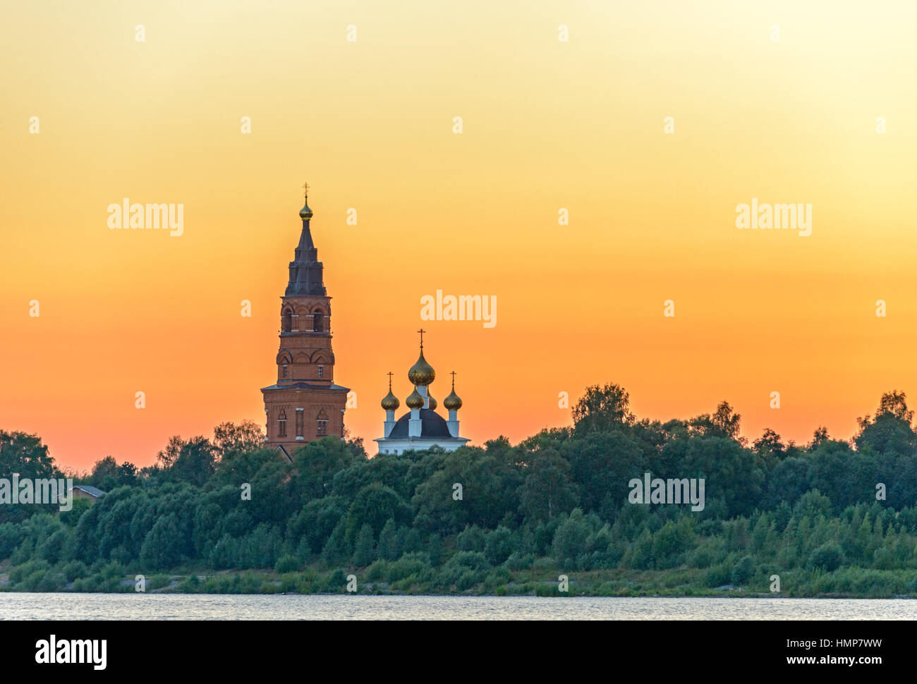 Old orthodox cathedral on bank of the Volga river in Russia over sunset ...
