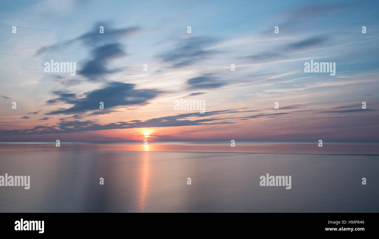 sunset over the sea with dramatic colorful sky Stock Photo - Alamy