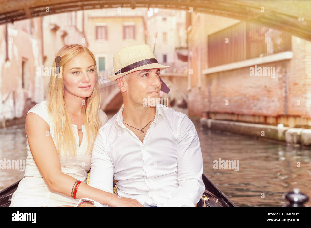 Portrait of a nice couple sitting in the gondola and enjoying wonderful ...
