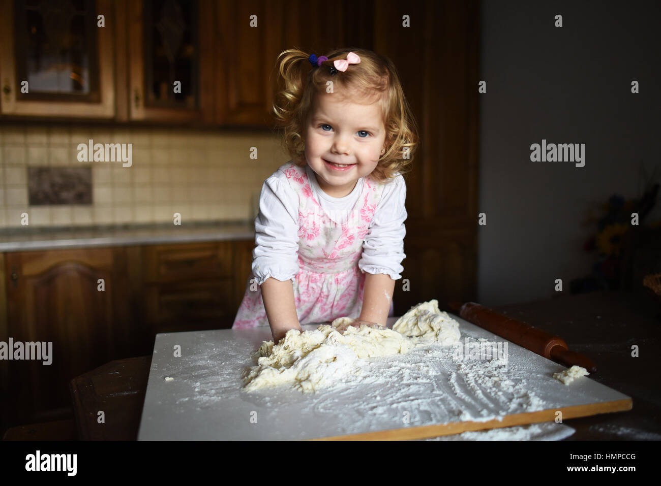 little girl kneading dough Stock Photo Alamy