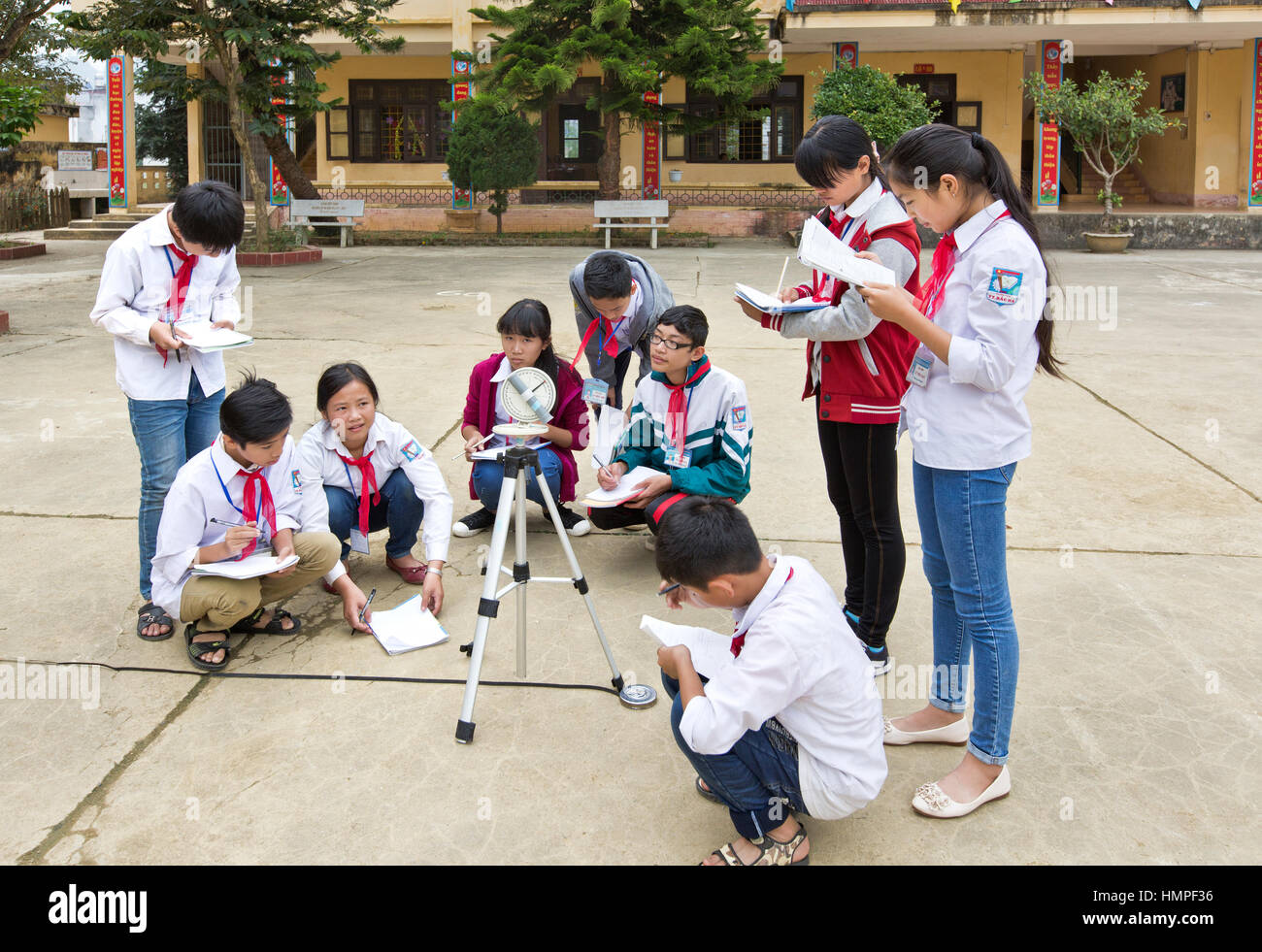 School children attending outdoor classroom, learning how to operate a sextant, Thai Giang Boarding School. Stock Photo
