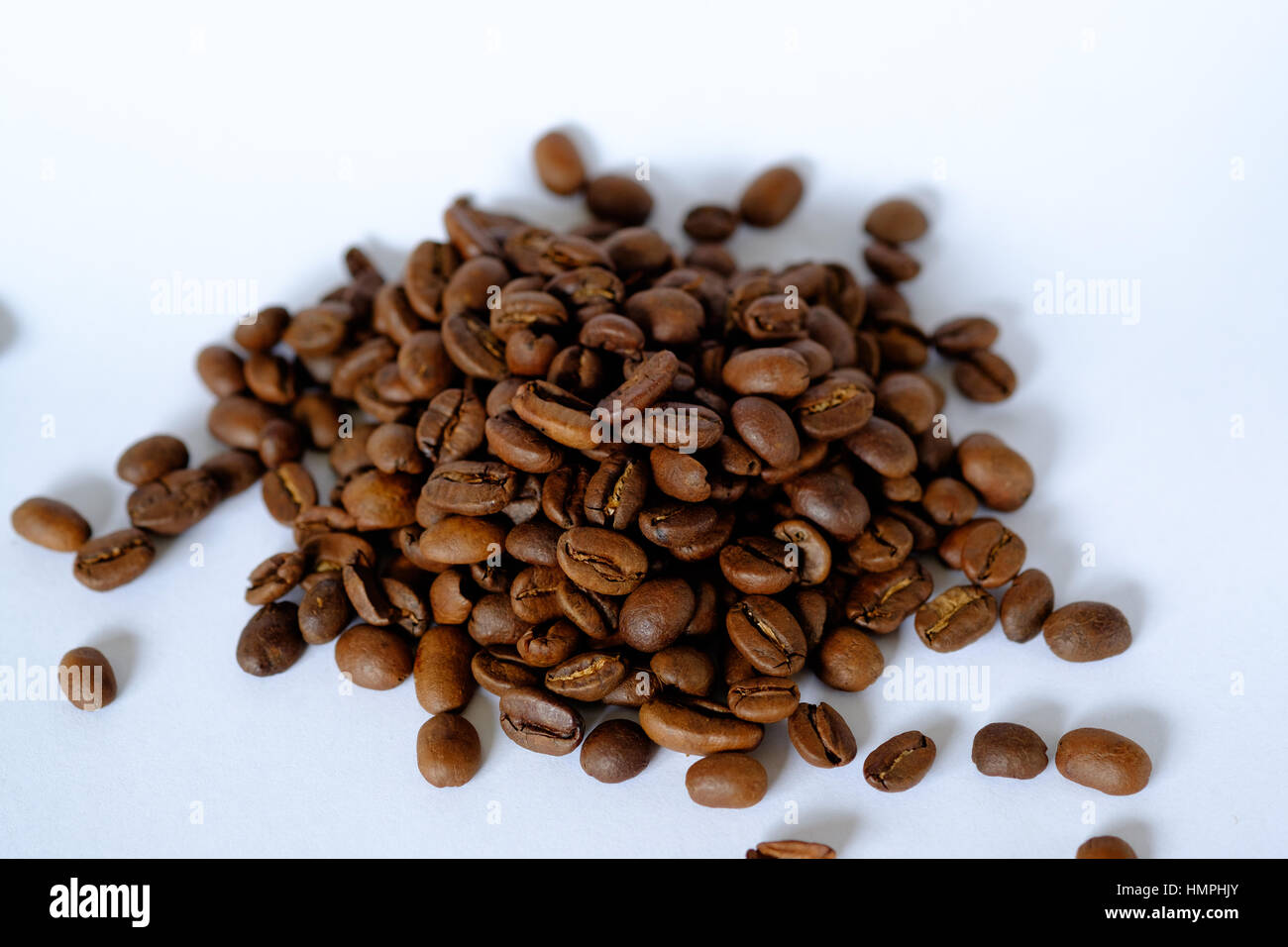 Small pile of roasted coffee beans on a white background Stock Photo ...