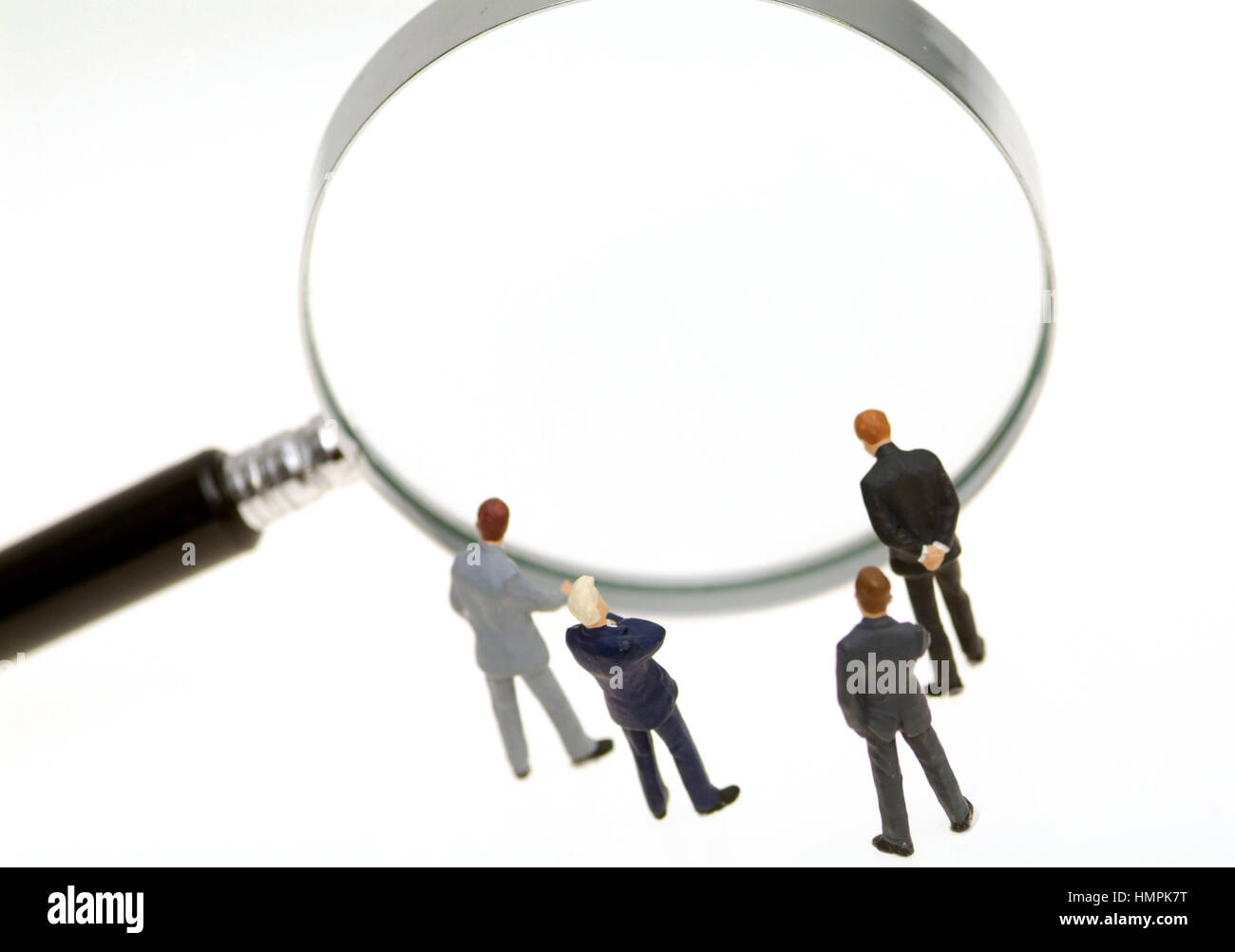 Business people looking through a loupe Stock Photo - Alamy