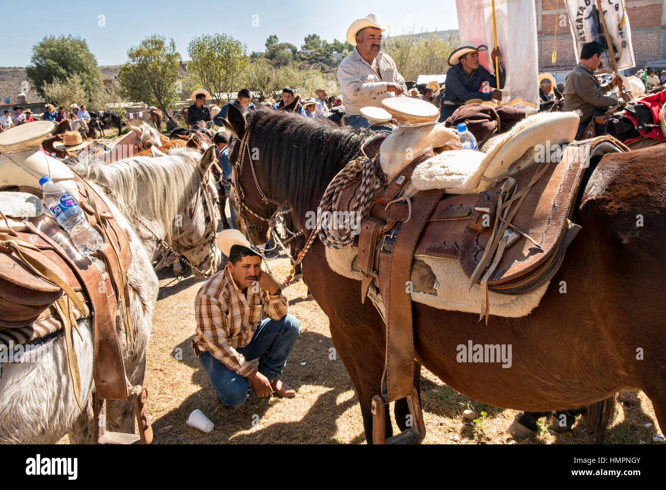 Mexican cowboys pray during Catholic mass at the San Martin de Terreros church during the annual Cabalgata de Cristo Rey pilgrimage January 4, 2017 in Guanajuato, Mexico. Thousands of Mexican cowboys and horse take part in the three-day ride to the mountaintop shrine of Cristo Rey stopping along the way at shrines and churches. Stock Photo
