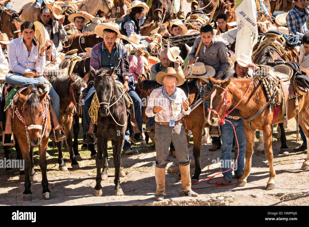 Mexican cowboys pray during Catholic mass at the San Martin de Terreros church during the annual Cabalgata de Cristo Rey pilgrimage January 4, 2017 in Guanajuato, Mexico. Thousands of Mexican cowboys and horse take part in the three-day ride to the mountaintop shrine of Cristo Rey stopping along the way at shrines and churches. Stock Photo