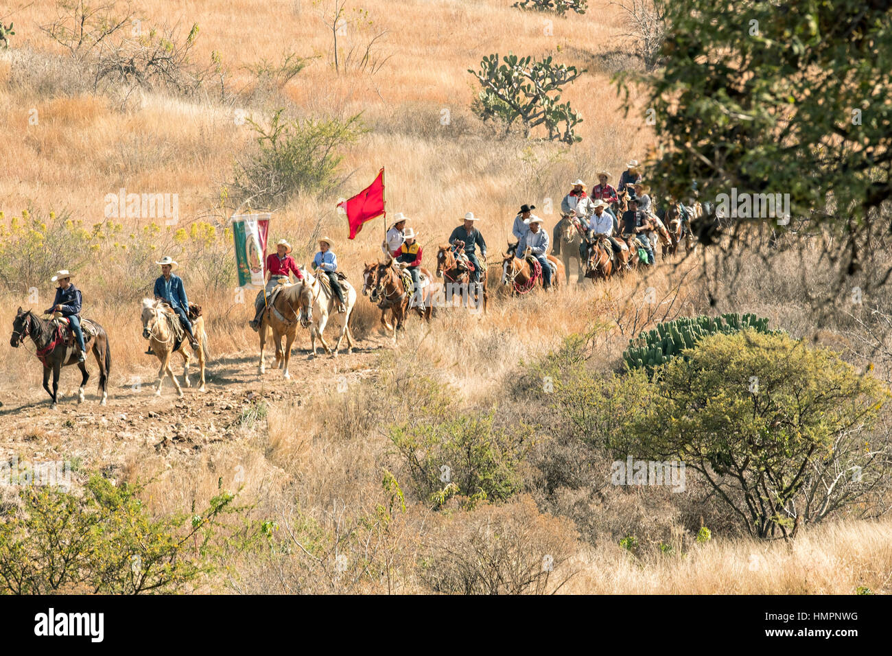 Hundreds of Mexican cowboys ride through the high desert during the annual Cabalgata de Cristo Rey pilgrimage January 5, 2017 in La Trinidad, Guanajuato, Mexico. Thousands of Mexican cowboys and horse take part in the three-day ride to the mountaintop shrine of Cristo Rey stopping along the way at shrines and churches. Stock Photo