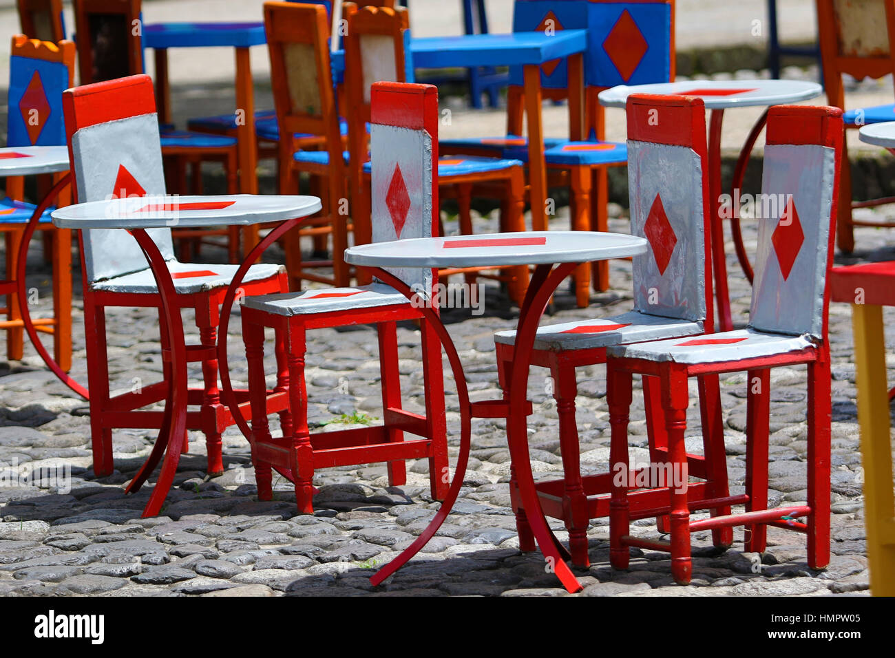 colourful cow hide chairs outdoors on coffee-shop patio in El Jardin Colombia Stock Photo