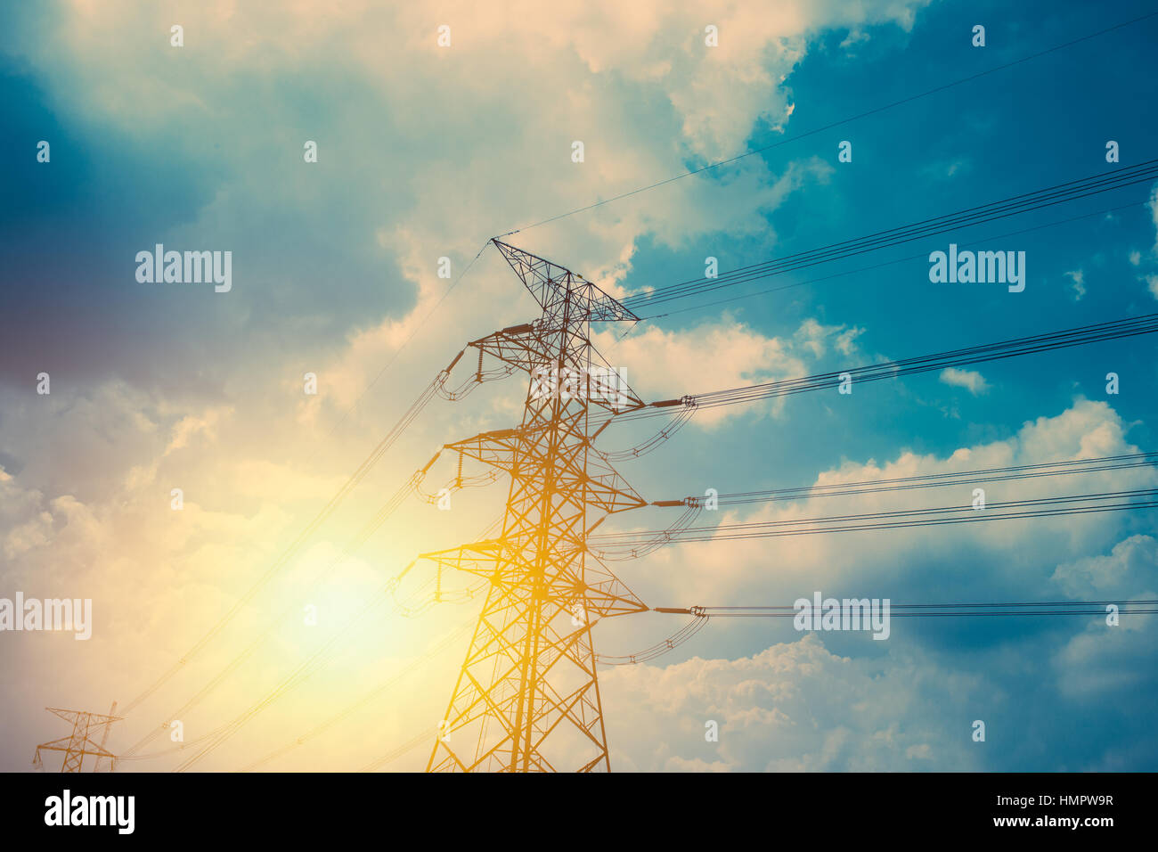 High voltage cable power post steel tower pylons in sunset scene ...