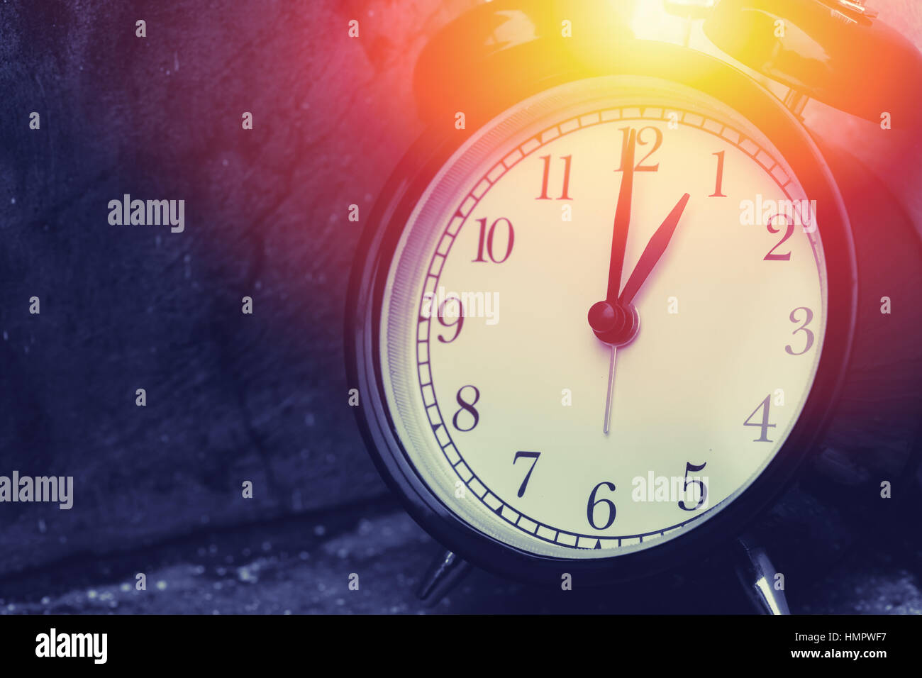 1 o'clock vintage clock at dark color tone with sun light memory time
