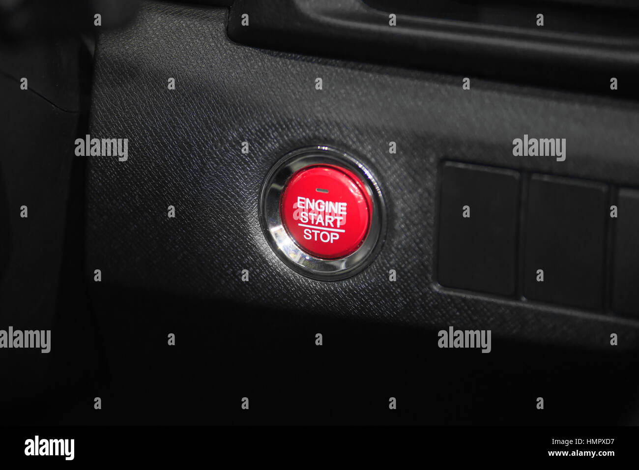 Detail close up of red engine start stop car button in modern car. Stock Photo