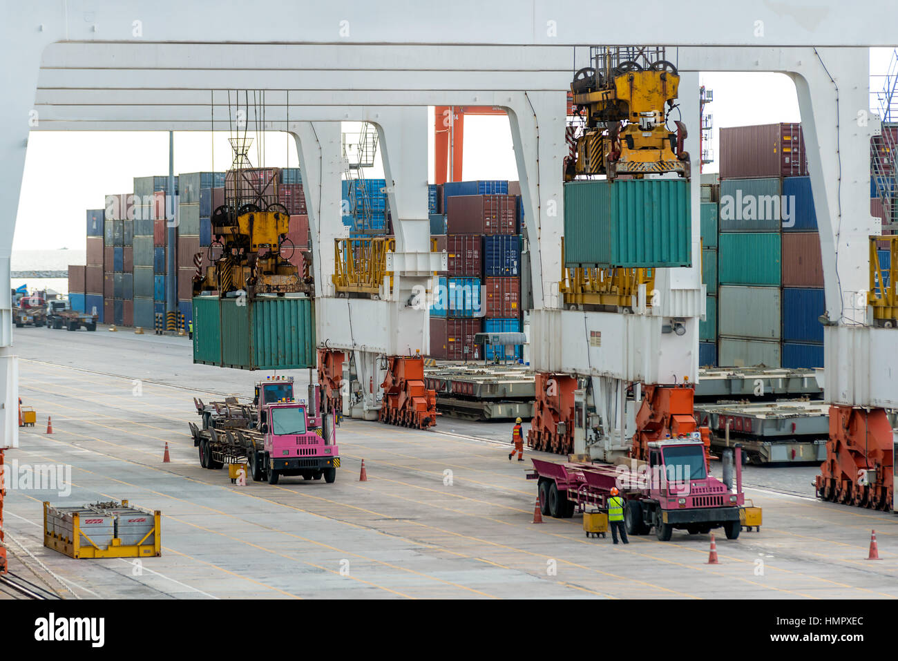 Container cargo freight ship with working crane loading bridge in