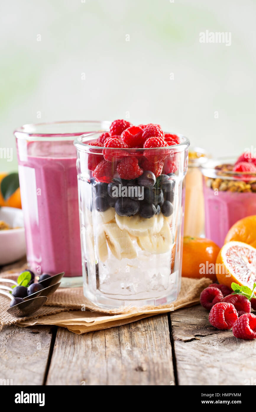 Raspberry, blueberry and banana smoothie ingredients in tall glass