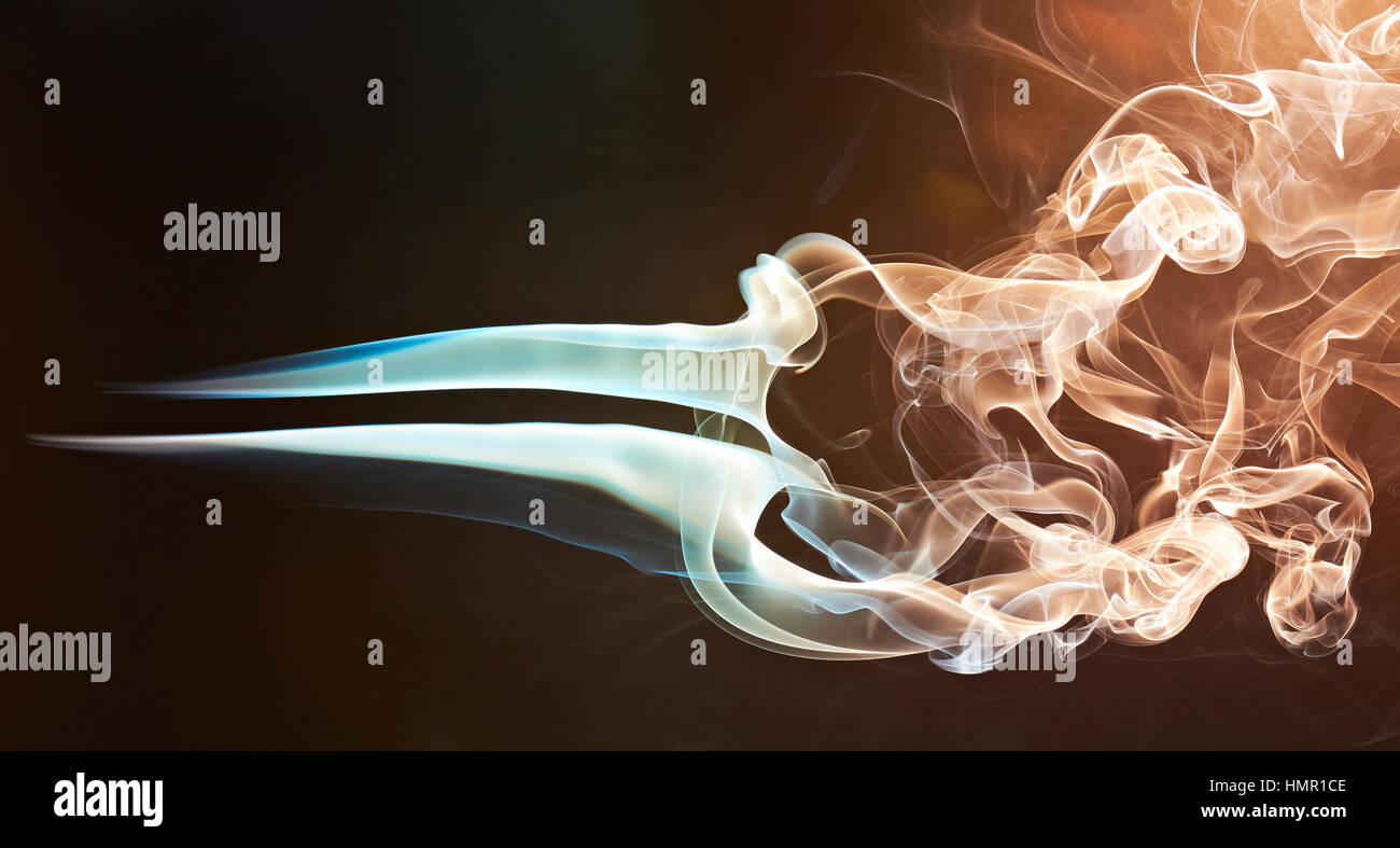 smoke blue silky curles isolated on brown background Stock Photo