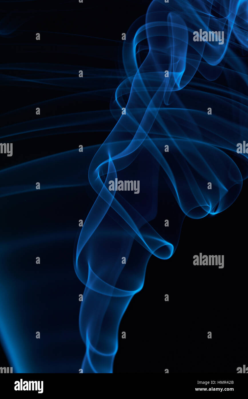 macro of blue smoke curves on black background Stock Photo - Alamy