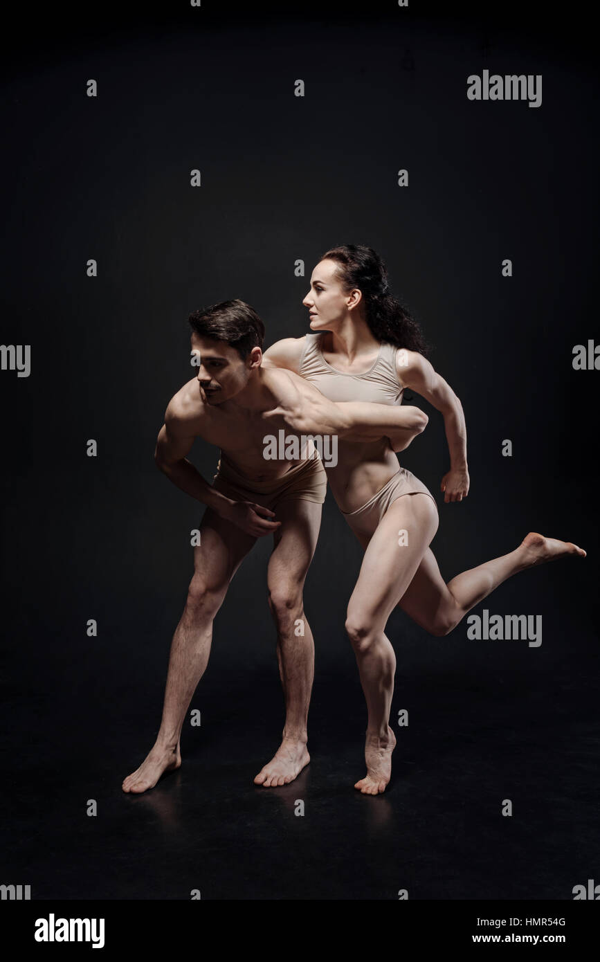 Muscular gymnasts performing together in the studio Stock Photo
