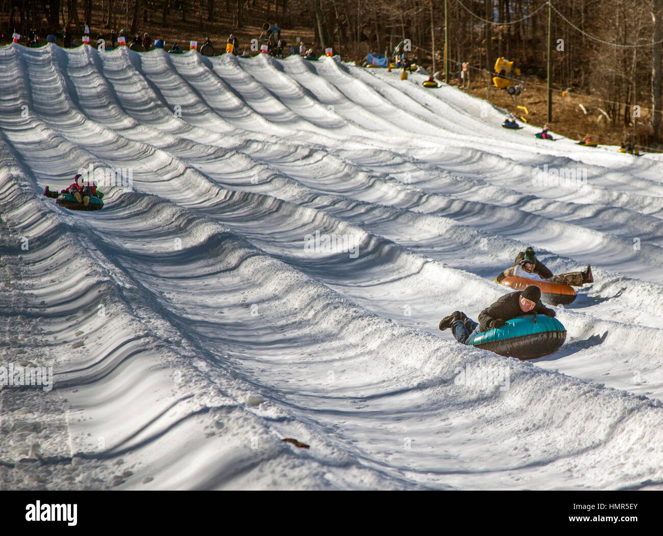 Snow tubing down a hill Stock Photo Alamy
