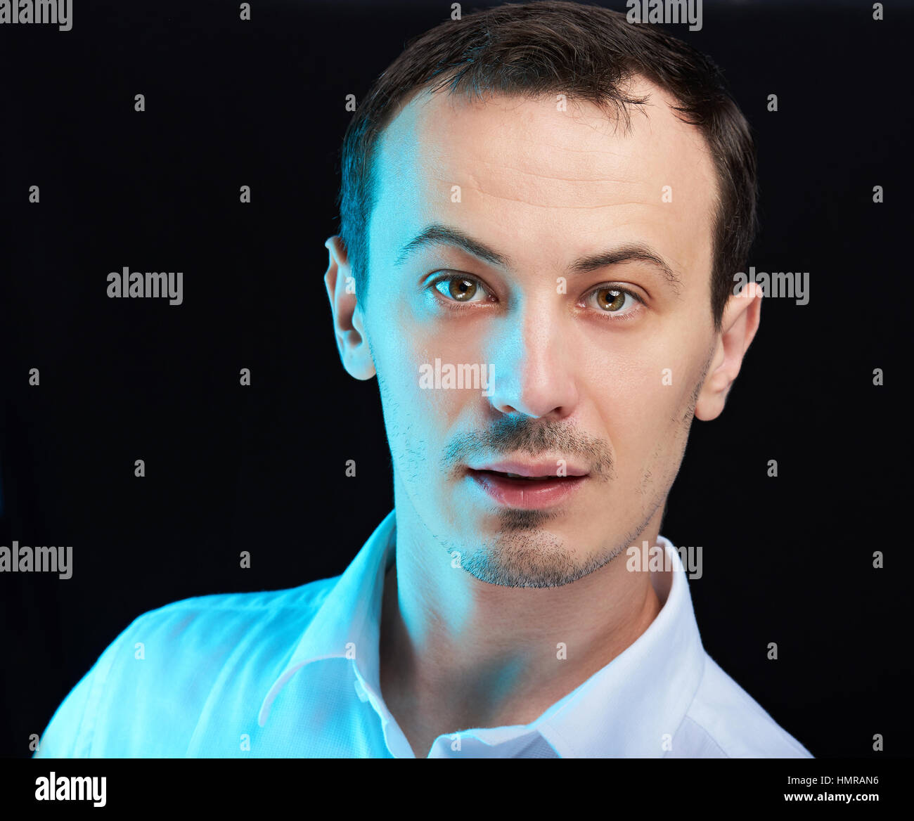 close up portrait  of young white man on black Stock Photo