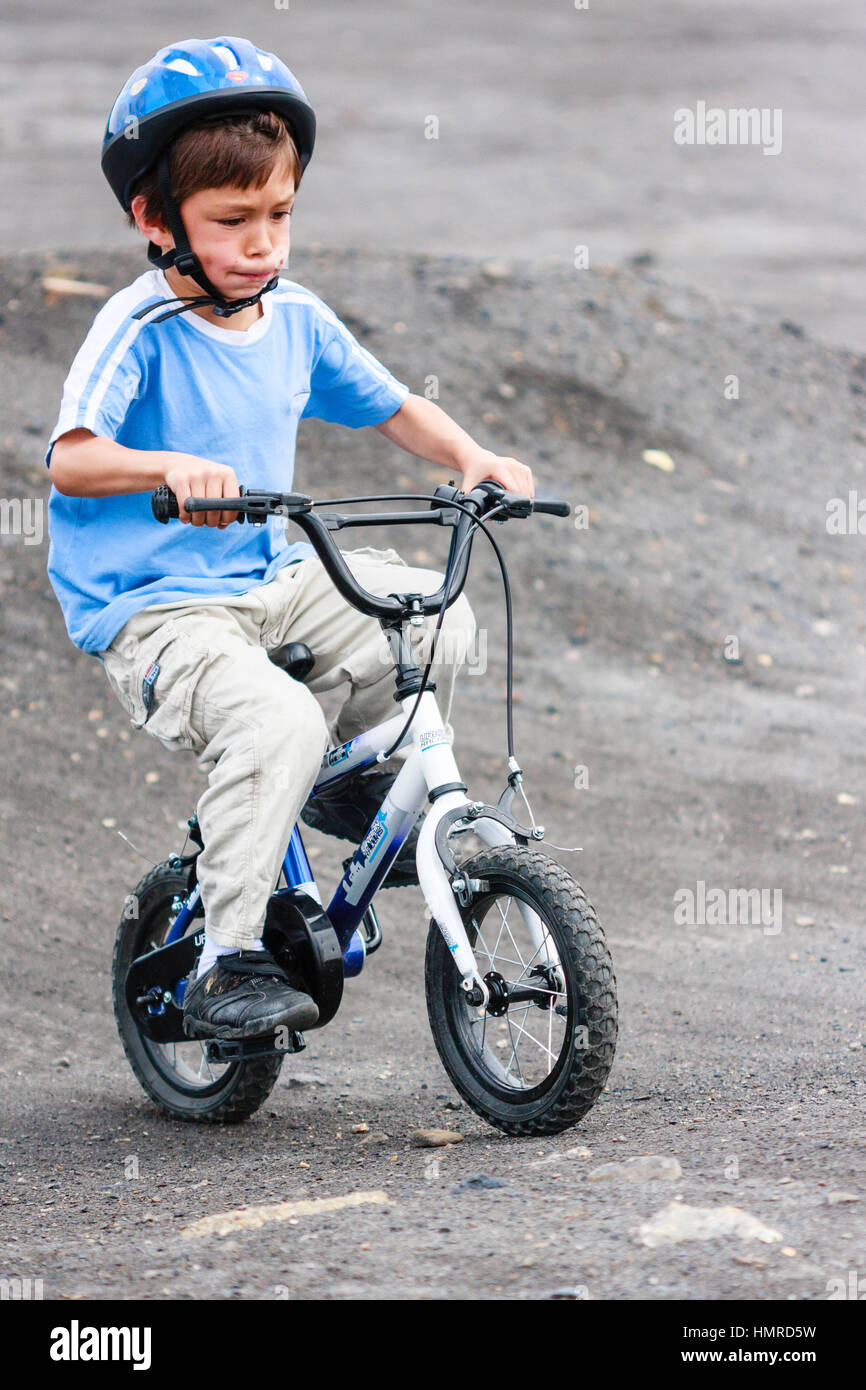 Caucasian child boy 8 9 years peddling child #39 s bike on dirt trail Caucasian child boy 8 9 years peddling child #39 s bike on dirt trail