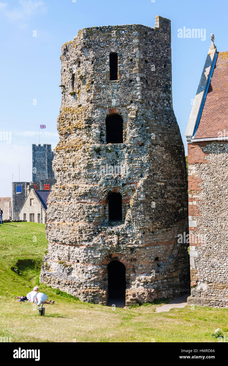 Dover castle, the Pharos, Roman Lighthouse, the oldest building in England. Daytime, blue sky. The main castle keep in background behind lighthouse. Stock Photo