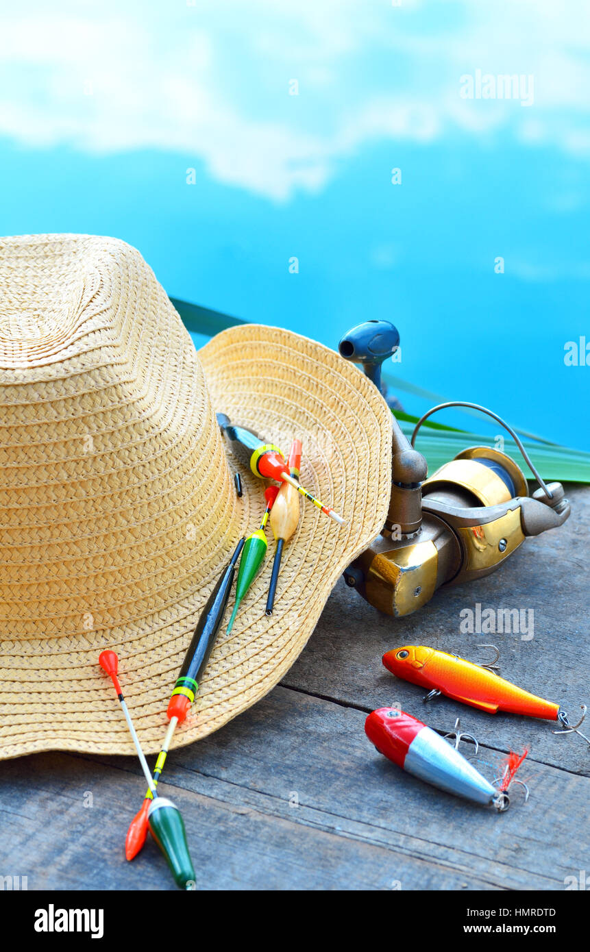 Cowboy hat, fishing floats and reeds in the nature Stock Photo - Alamy