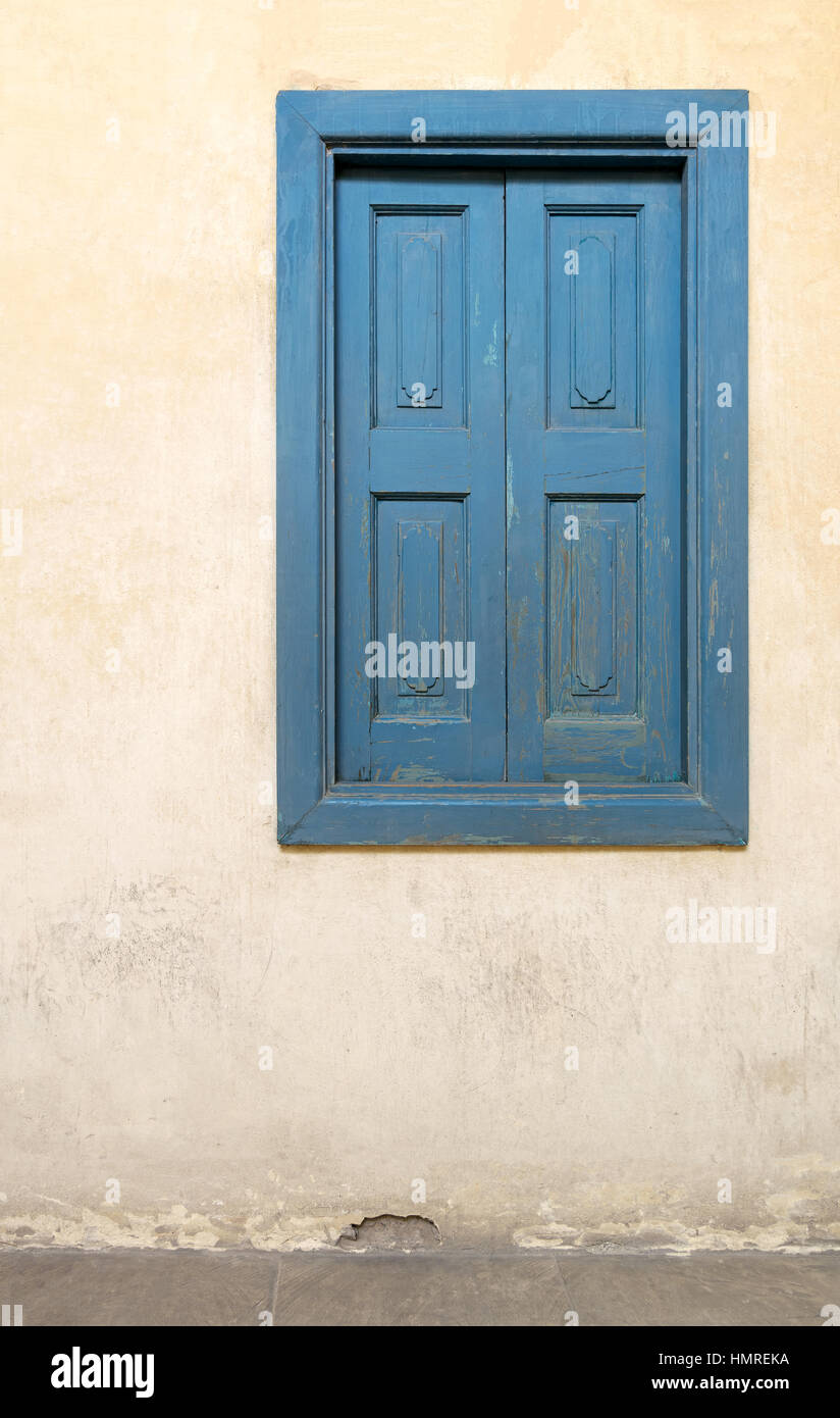 Blue wooden window of a old historic building with vintage plaster wall ...