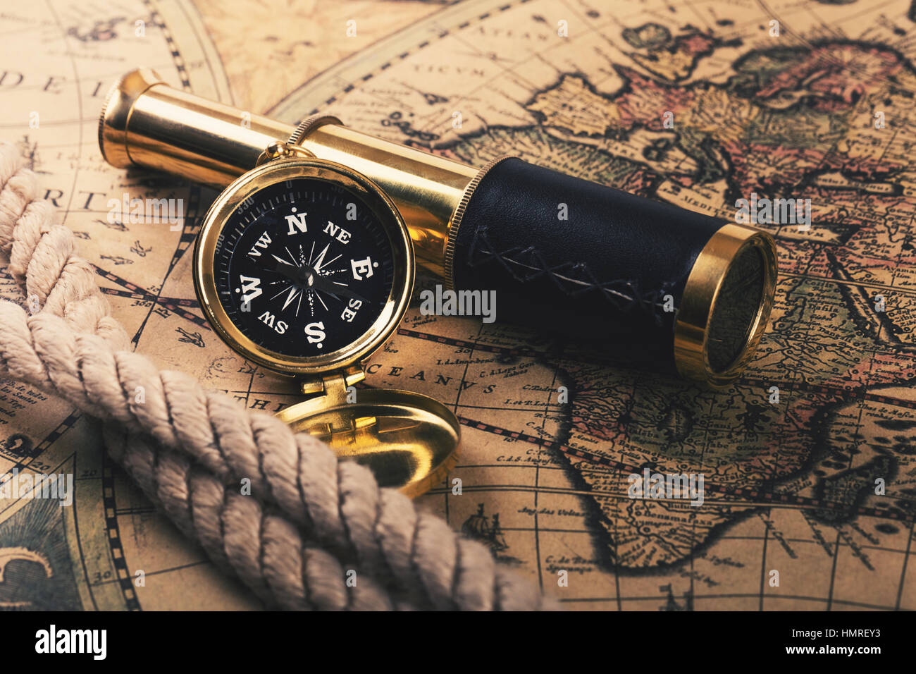 adventures concept - vintage compass and spyglass on old world map ...