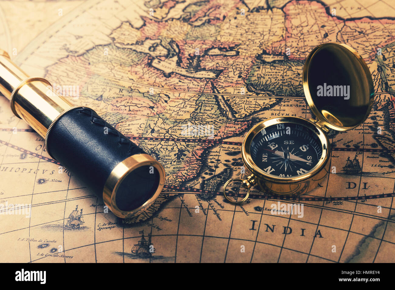vintage compass and spyglass on old world map Stock Photo
