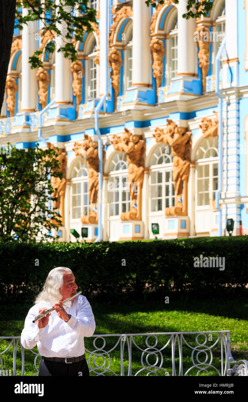 white haired man playing the flute in front of Catharines palace, st petersburg, russia Stock Photo
